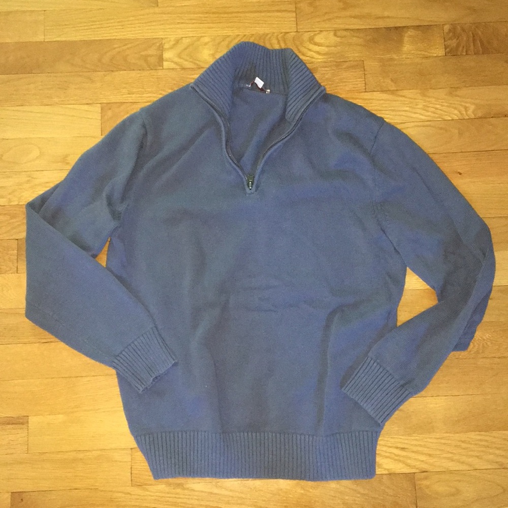 Blue quarter-zip sweater.